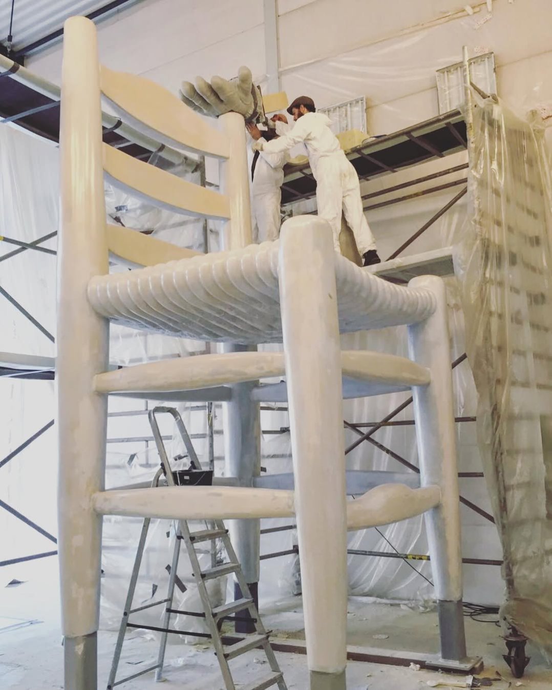 Here you can see the process of large sculpture making. The chair is made out of metal and hard foam that we sculpt by hand with a saw and knife, and as last a fiberglass like coating for strength and weather resistance. . #art #largescale #sculptures #artist